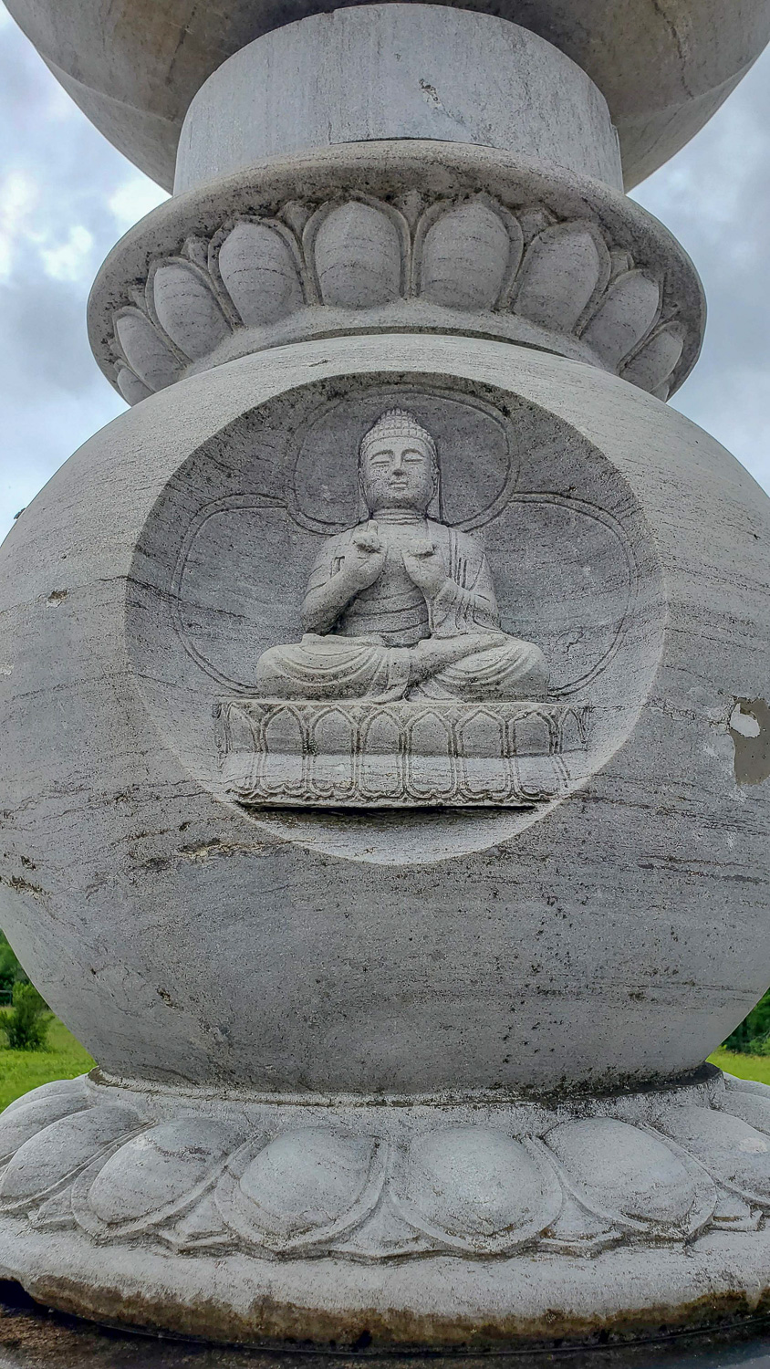 Up close detail of a Buddha statue within a tower